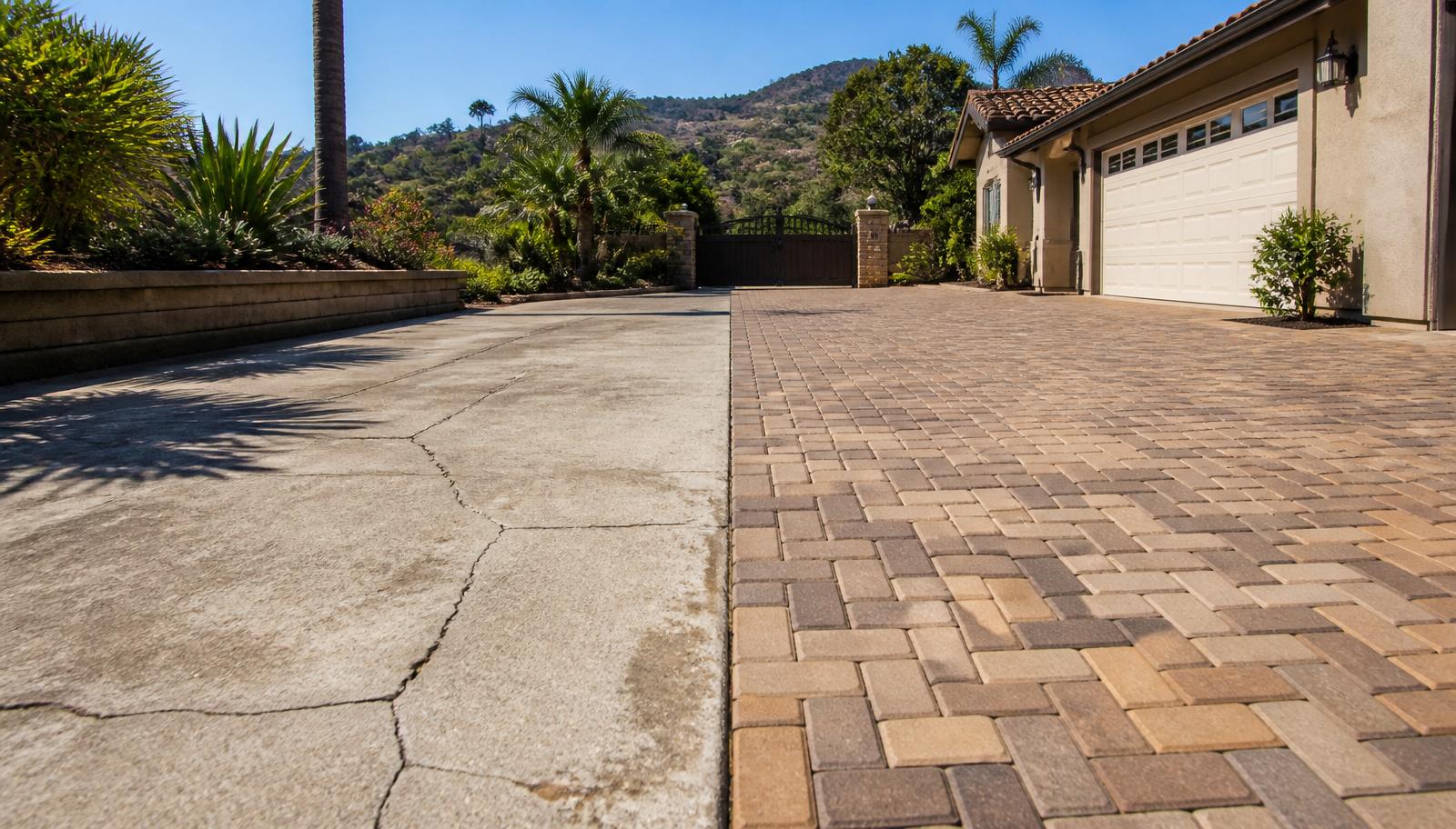 Split comparison of cracked concrete driveway versus a new interlocking paver driveway